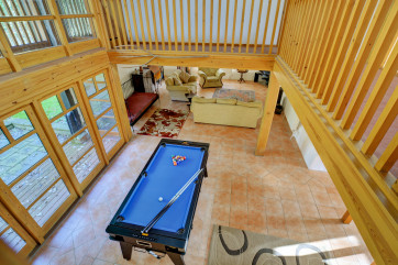 From the galleried landing you can look down to the pool table in the hall below