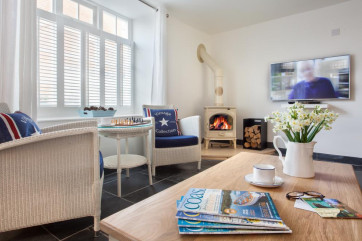 Bright, spacious, cosy lounge accentuated by a wood burning stove & 48