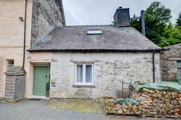 A tiny stone cottage to the rear of the owner's large Country House