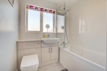 Bathroom with overhead shower on bath