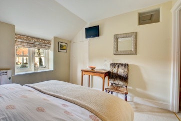 The main bedroom is decorated in neutral tones to create a peaceful atmosphere