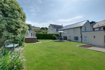A superb cottage in the centre of the character village of Croyde with ample external space and a hot tub