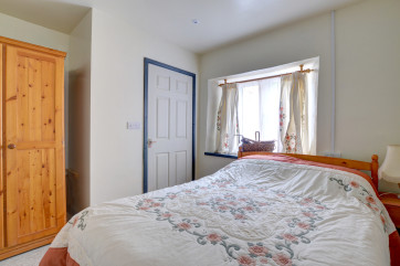 A compact double bedroom but with clear access between door, bed and wet room