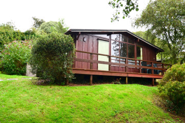 Exterior shot of the lodge, situated in a popular holiday park