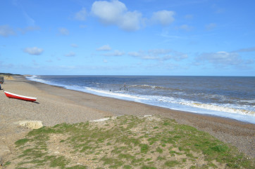The shingle beach and coastal path are just a short stroll from the property