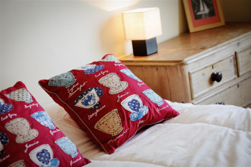 Soft furnishings have been placed on the king size bed to make it feel more like a home from home