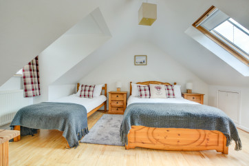 This bedroom has both a double bed and single bed
