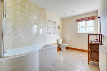 Stunning modern bathroom with bath and overbath shower