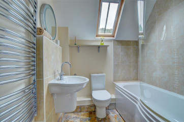 The contemporary bathroom has underfloor heating and a heated towel rail