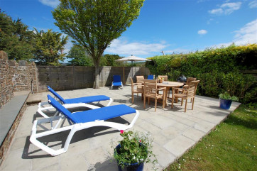 Fully enclosed mature lawned garden with a large patio