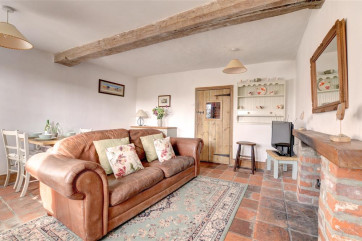 Lovely cosy sitting room with rustic open beams and multi fuel stove