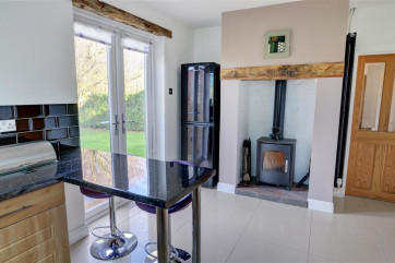Another woodburner within the spacious kitchen