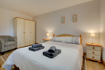 Double bed with useful bedside tables and lighting.