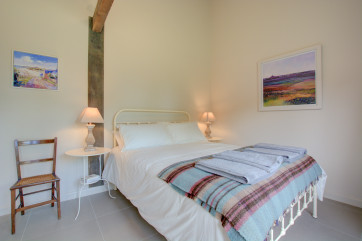 Bedroom 1 with King Size bed, bedside tables, lamps & chairs