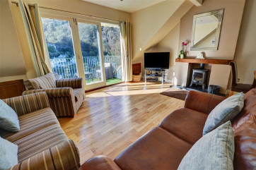 Comfortable seating, woodburner and large TV