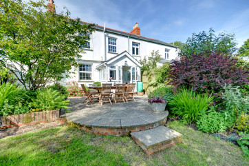 The patio area with steps down to the garden