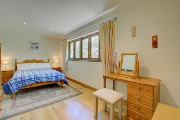 Double bed and wooden bedroom furniture.