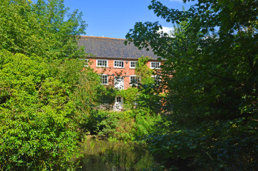 Quietly situated in an idyllic rural position one mile from the town centre, this 200-year-old mill faces south and is located directly over the mill stream, offering glorious views of the surrounding countryside.