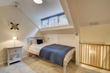 Further steep stairs to the second floor opens out into a second attractive bedroom with sloping ceiling and twin beds