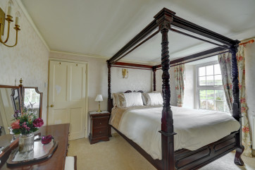 The beautiful master bedroom with King four poster, dressing area and en suite bathroom