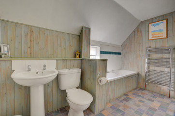 A well equipped bathroom with bath and seperate shower cubicle.