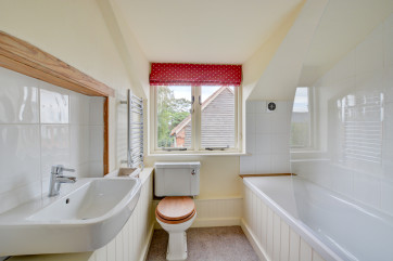 Bathroom with bath, over bath shower, washbasin and wc