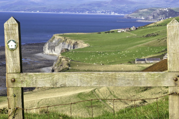 Wales Coast Path: View over stile near Llanrhystud north towards Aberystwyth