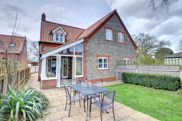 Pleasant garden area from conservatory with table and chairs