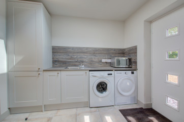 Utility room with fitted units, washing machine & tumble dryer