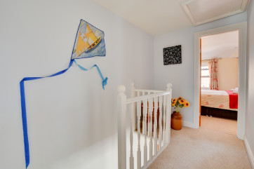 The artwork kite on the wall is quirky and fun.