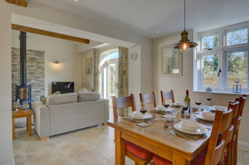 Dining table set for dinner with white china and wine