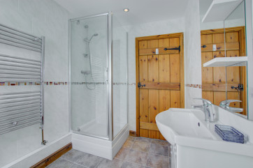 Shower cubicle and heated towel rail.