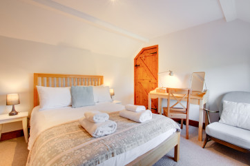 Double bedroom is cosy with beautiful soft furnishings