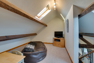 Cosy ‘snug’ room with DVD player, Playstation 2, toys and games – perfect retreat for children.