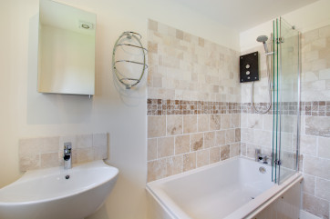 Bathroom with over bath shower