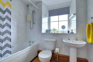 Family bathroom with electric shower over the bath