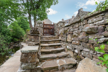 Steps leading down to the stream, waterfall and patio area