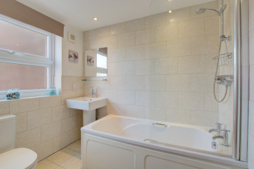Sparkling white bathroom, heated towel rail.