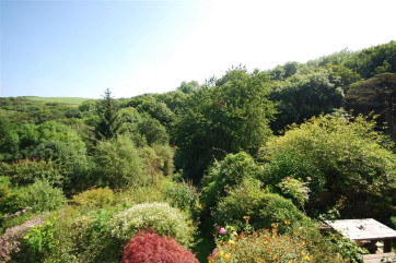 The property is nestled in a tranquil wooded valley surrounded by ancient trees