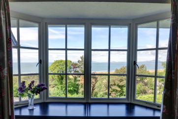 The living room has a gorgeous view over the sea to the Lleyn Peninsula