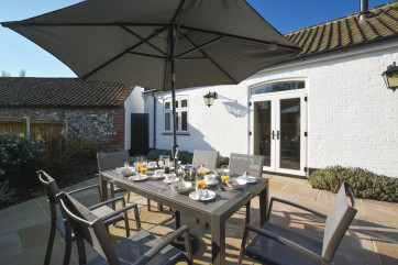 Outside patio with furniture and umbrella
