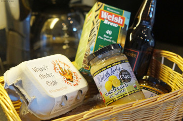 A spacious, cream 'shaker' style kitchen with a farmhouse pine table.