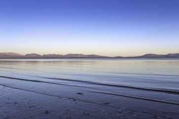 Calm sea at sunset from Newborough Beach