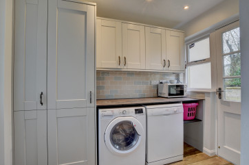 The useful utility room with dishwasher and washer/dryer is just off the kitchen