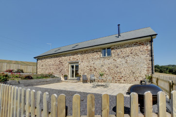 The high quality converted barn has a large enclosed patio area and plenty of space for parking