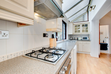Galley style kitchen with views to the rear area of the property