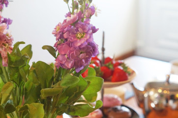A spacious, cream 'shaker' style kitchen with a farmhouse pine table.