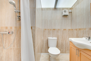 The shower room with toilet and wash basin