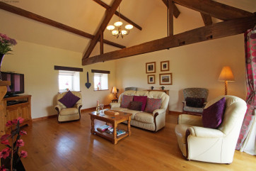 Living room with solid oak floor and comfortable, large leather sofas