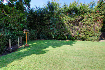 Fully enclosed rear garden with a lovely lawn and mature hedges